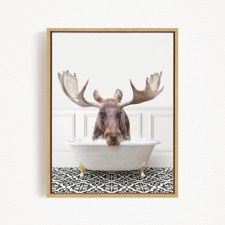 A moose with large antlers is sitting in a bathtub filled with water, creating a whimsical and humorous scene.