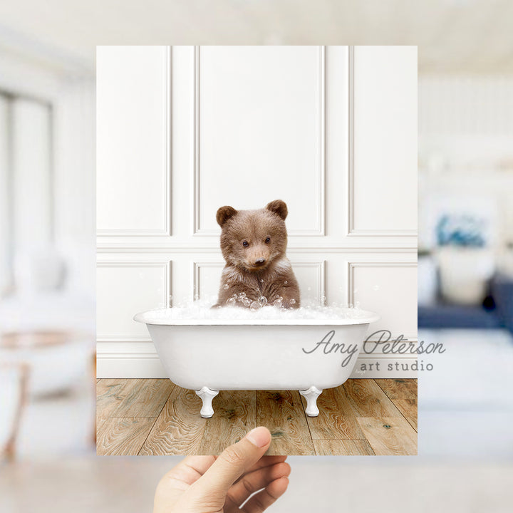 a small teddy bear sitting in a bath tub