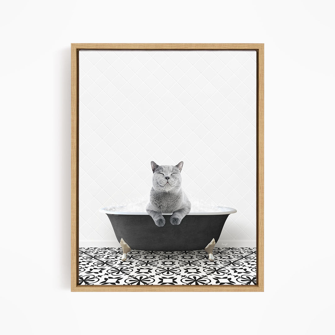 A gray cat sitting in a bathtub filled with bubbles, looking relaxed and content.
