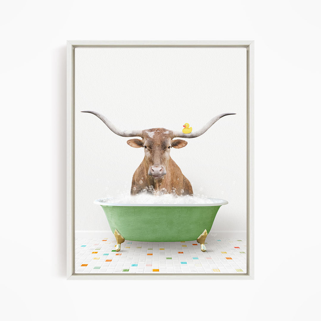 A brown cow with large horns is sitting in a green bathtub filled with bubbles, with a yellow rubber duck floating on the water.