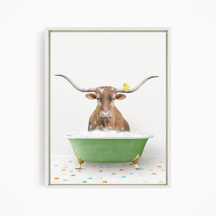A brown cow with large horns is sitting in a green bathtub filled with bubbles, with a yellow rubber duck floating on the water.