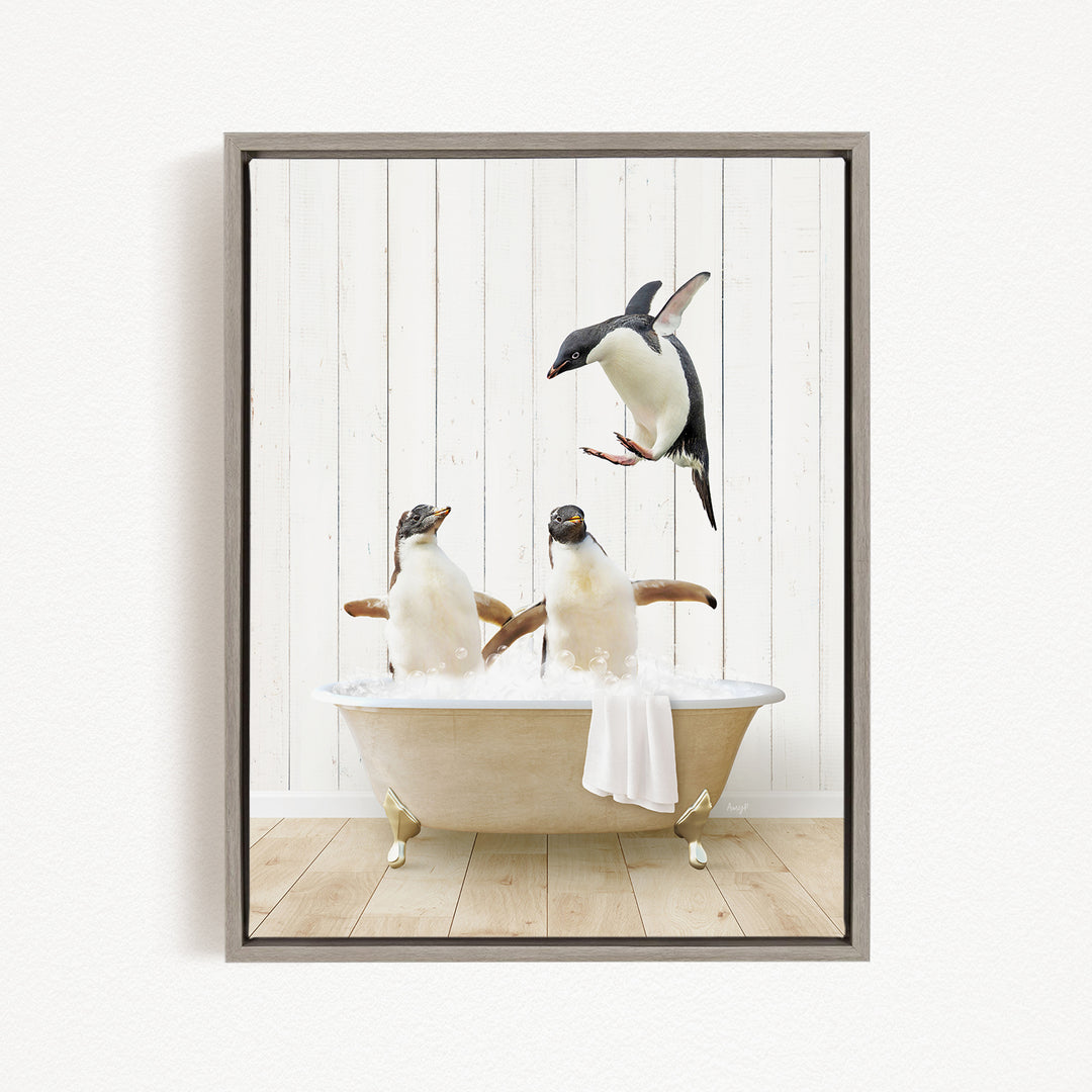 A framed image depicting three penguins sitting in a bathtub, with one penguin flying towards the others.
