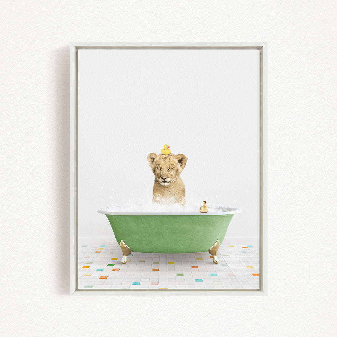 A lion cub is sitting in a green bathtub filled with bubbles, surrounded by rubber ducks.