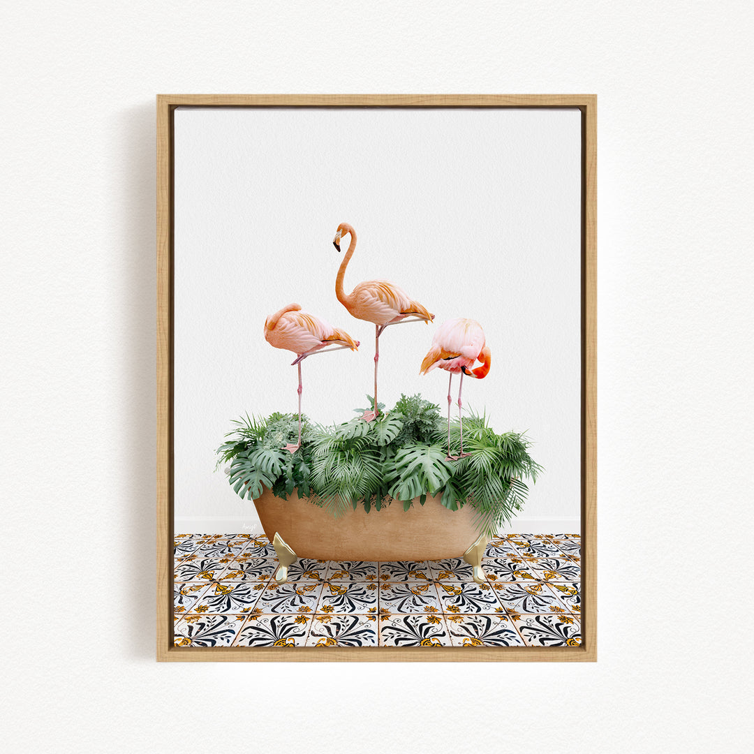 A framed image of three pink flamingos standing on stalks in a planter filled with green plants.