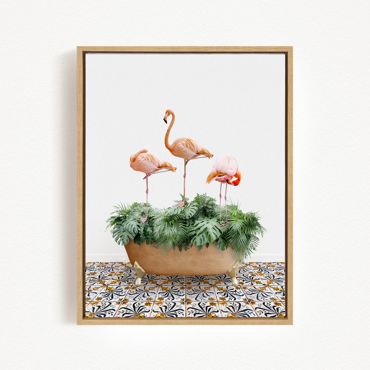 A framed image of three pink flamingos standing on stalks in a planter filled with green plants.