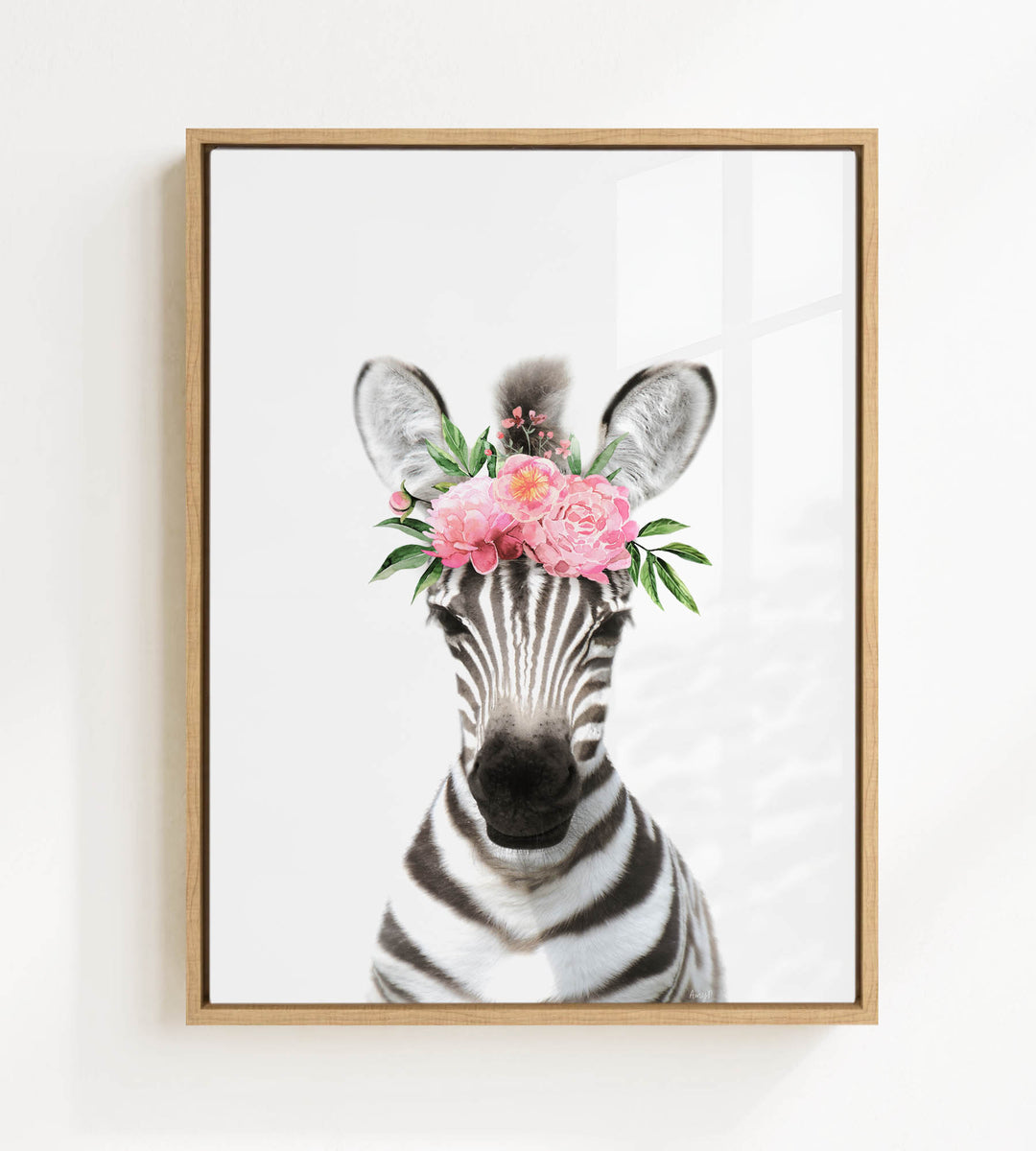 A zebra wearing a floral headpiece with pink flowers.
