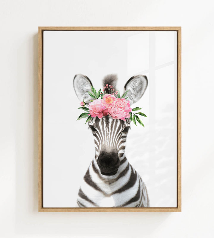 A zebra wearing a floral headpiece with pink flowers.