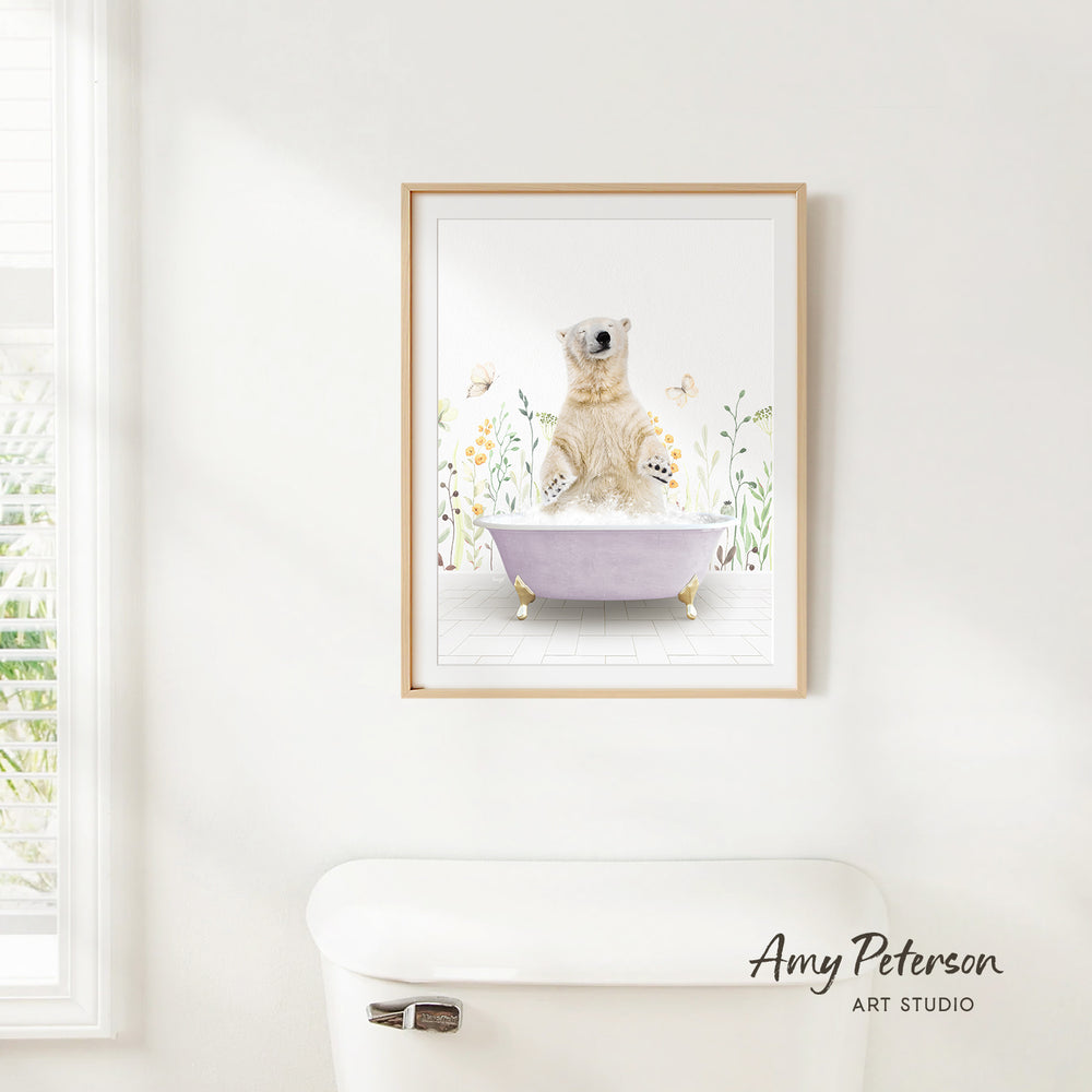 A framed print of a polar bear sitting in a bathtub is hanging on a white wall.
