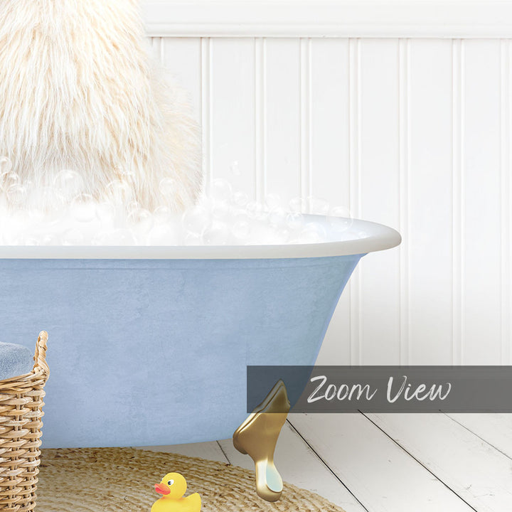 A fluffy white dog is sitting in a blue bathtub filled with bubbles, with a yellow rubber duck nearby.
