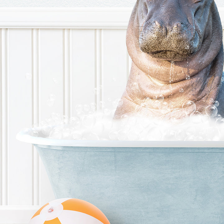 a hippo in a bathtub with bubbles and a beach ball