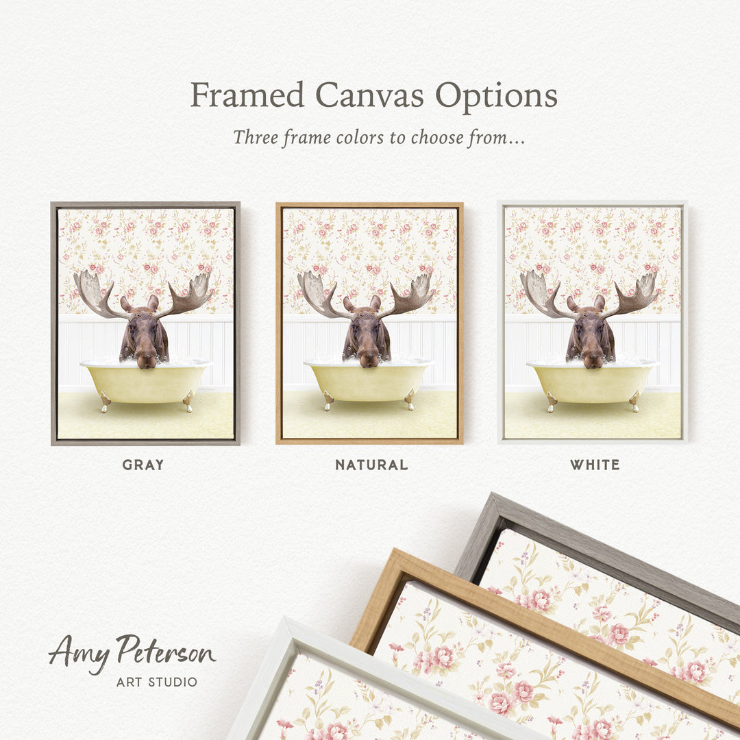 The image is a framed canvas option featuring a moose in a bathtub, with three different frame colors to choose from: gray, natural, and white.