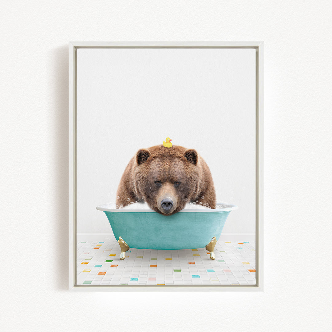 A brown bear is sitting in a blue bathtub, surrounded by colorful tiles on the floor.