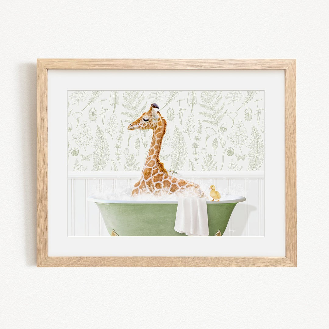 A giraffe sitting in a green bathtub, with a yellow duck nearby, against a backdrop of green ferns and leaves.