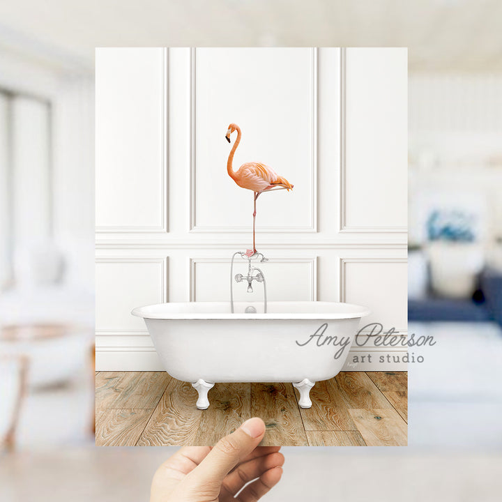 a pink flamingo standing on top of a bath tub