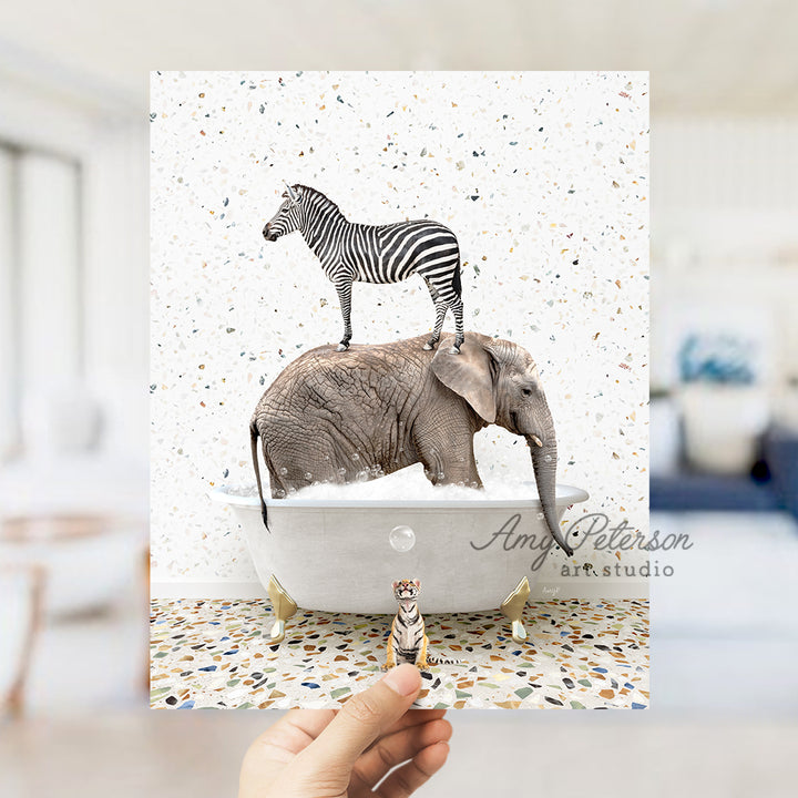 a person holding up a card with a picture of an elephant and a zebra on