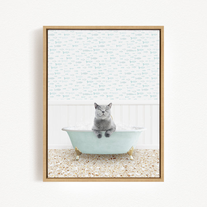 A gray cat sitting in a light blue bathtub, surrounded by a patterned tile floor and a white wall with a fish-themed wallpaper.