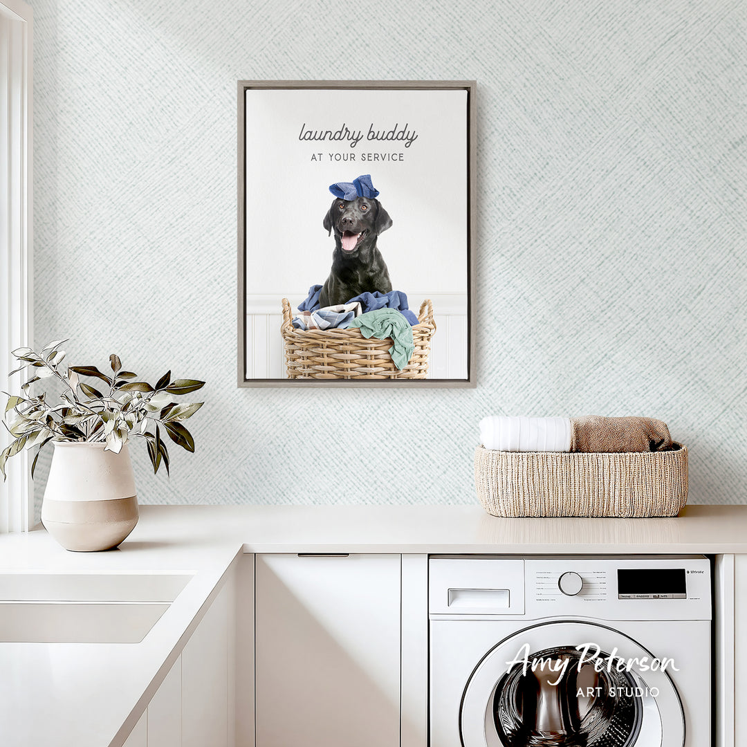 a black dog sitting in a wicker basket filled with clothes, placed on a white countertop in a laundry room.