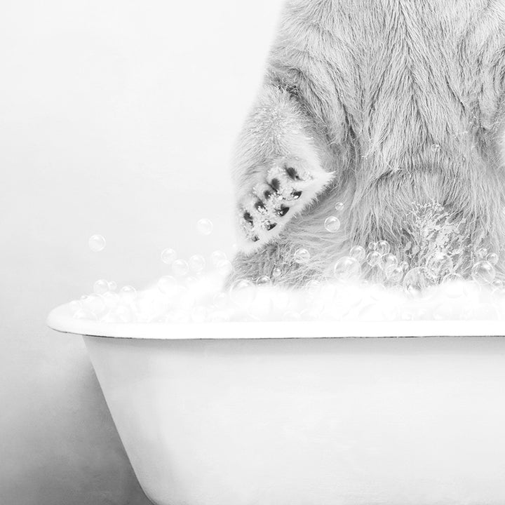 a black and white photo of a bear in a bathtub