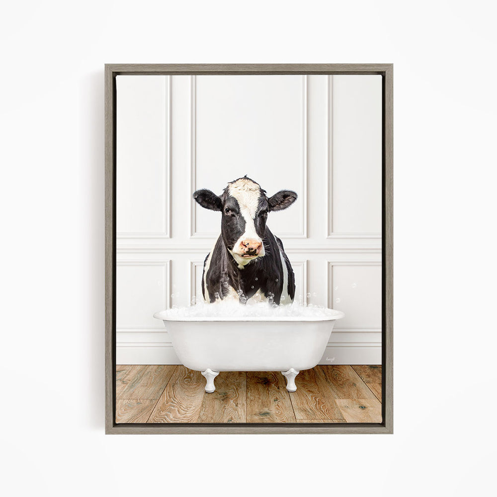 A black and white cow is standing in a white bathtub filled with water, creating a whimsical and humorous scene.