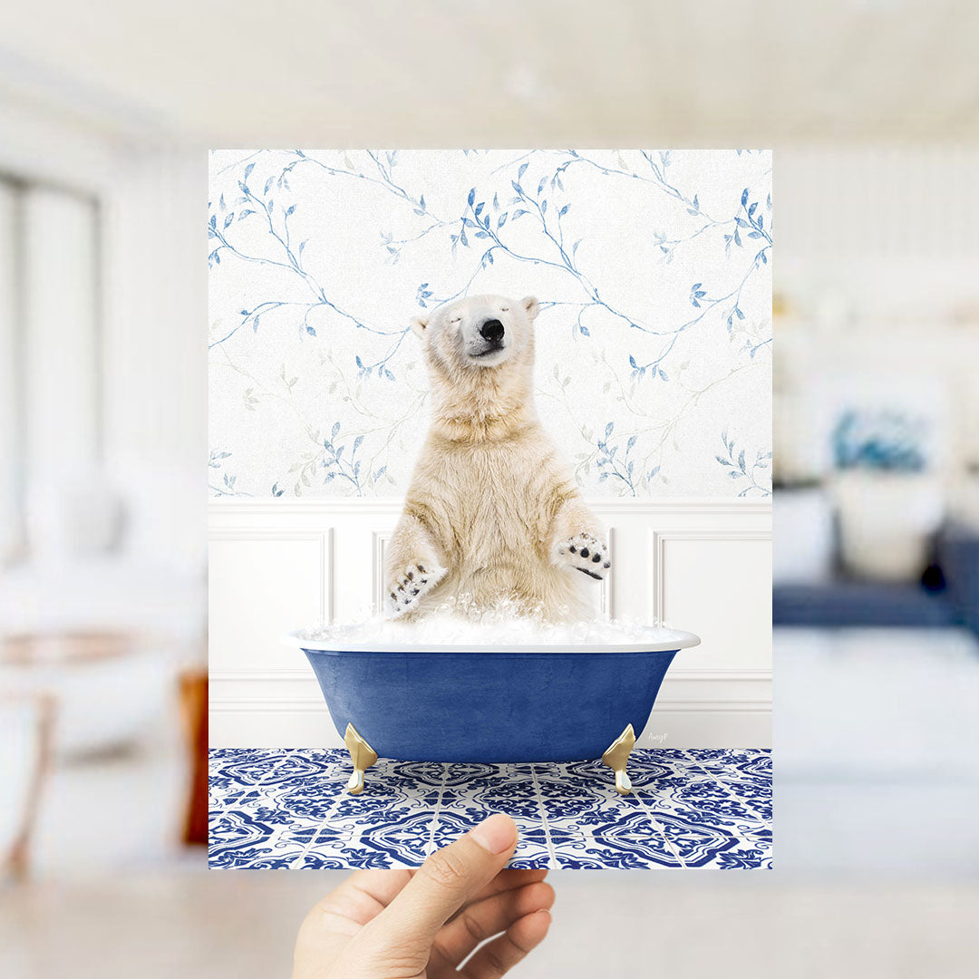 A polar bear sitting in a blue bathtub, surrounded by a patterned tile floor and a floral wallpaper.