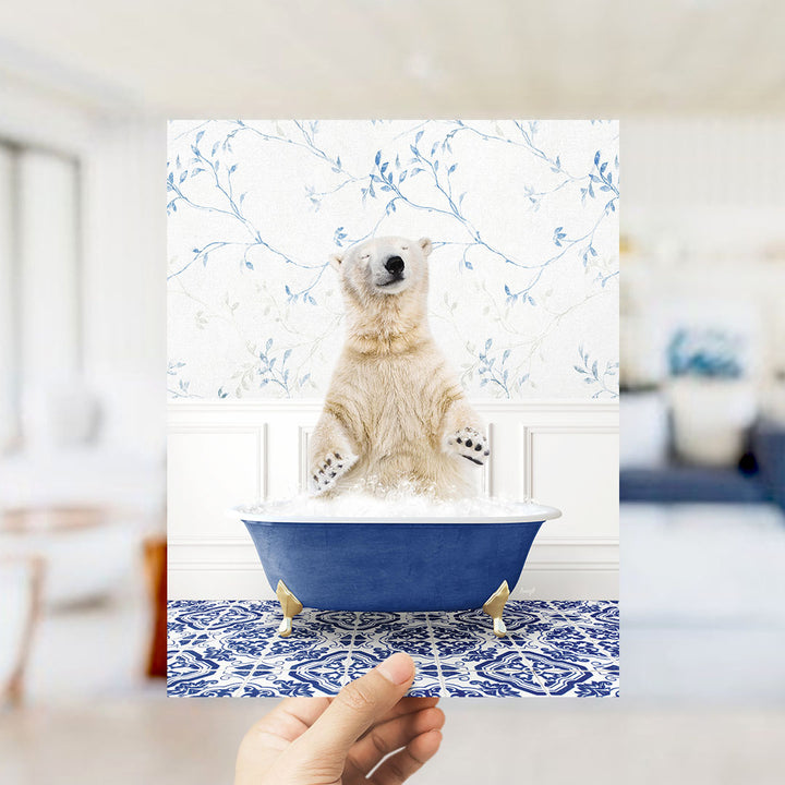 A polar bear sitting in a blue bathtub, surrounded by a patterned tile floor and a floral wallpaper.