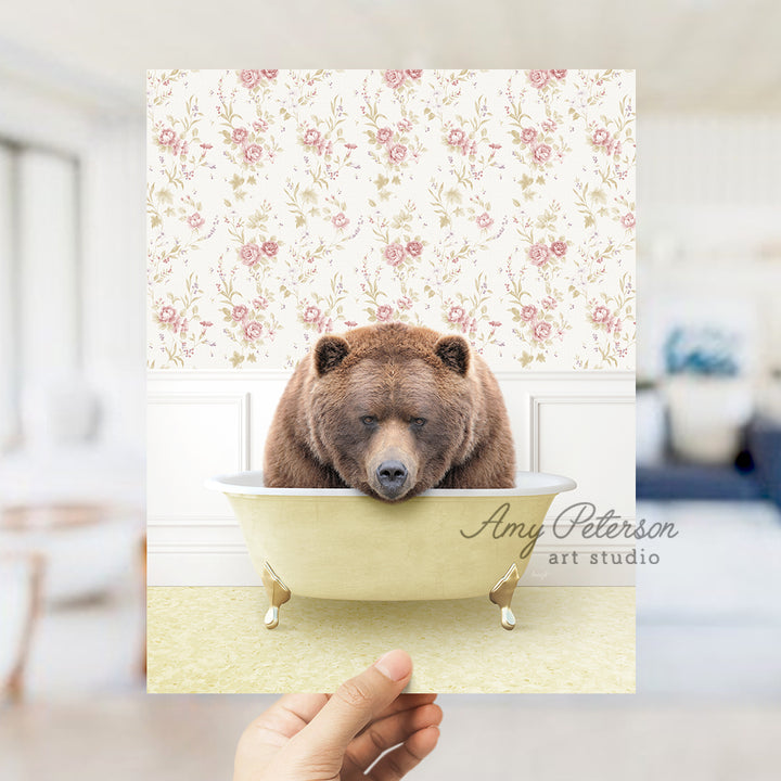 a person holding up a card with a bear in a bathtub