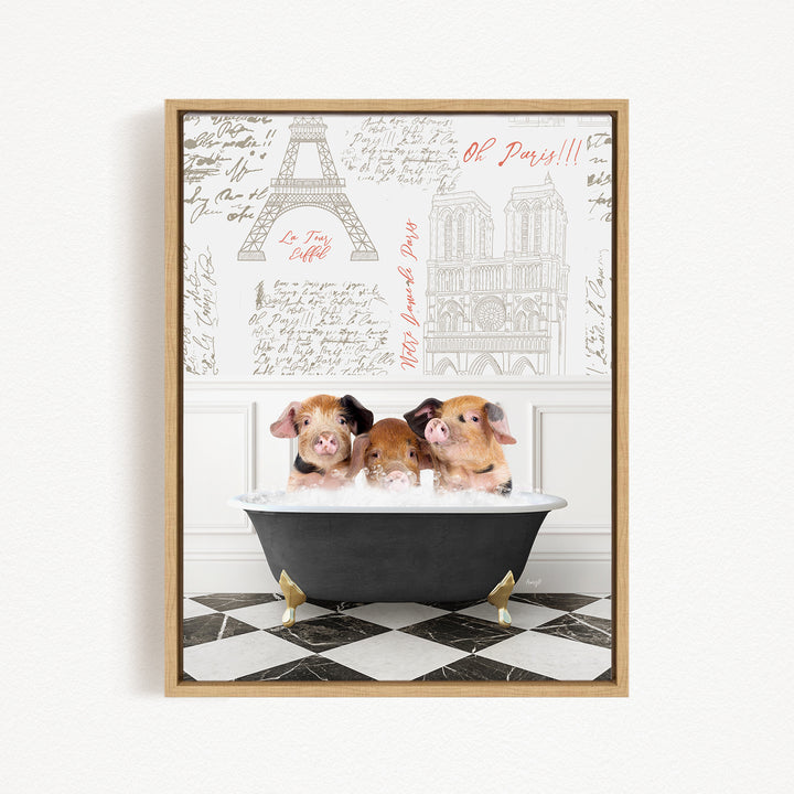 Three adorable pigs sitting in a bathtub, with a framed image of the Eiffel Tower in the background.