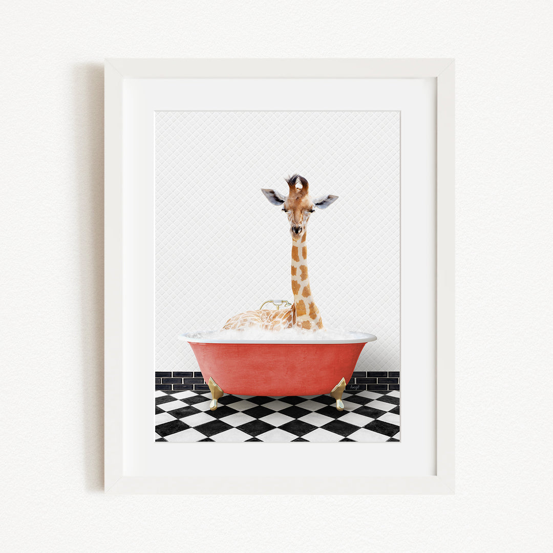 A giraffe is sitting in a red bathtub filled with bubbles, surrounded by a black and white checkered floor.