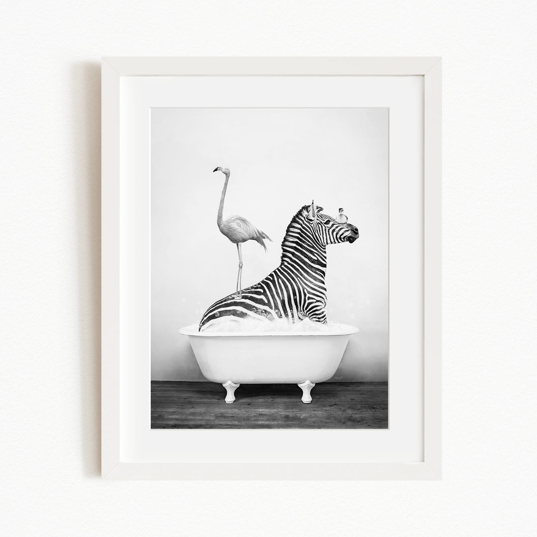 A zebra is sitting in a bathtub, with a flamingo standing on its back.