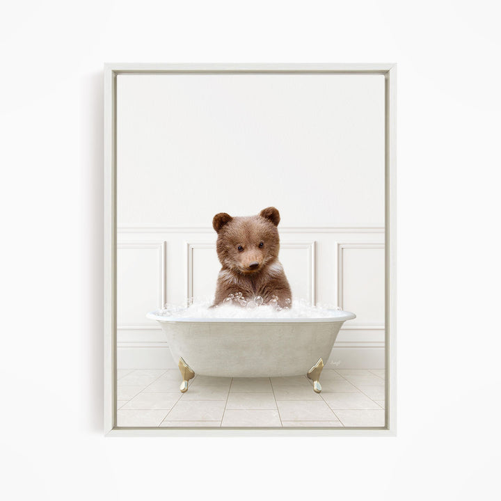 A brown bear sitting in a white bathtub filled with water, looking directly at the camera.
