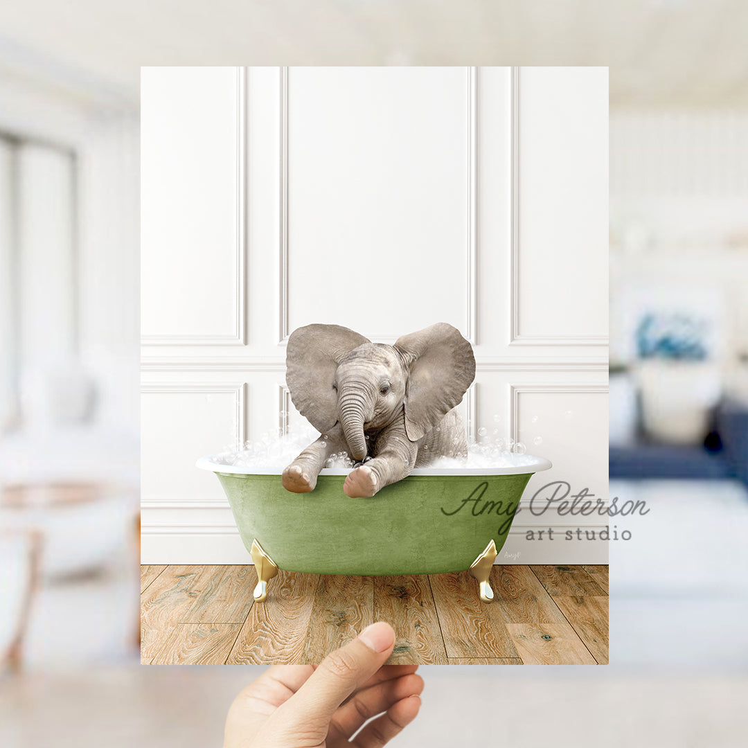 a person holding up a picture of an elephant in a bathtub