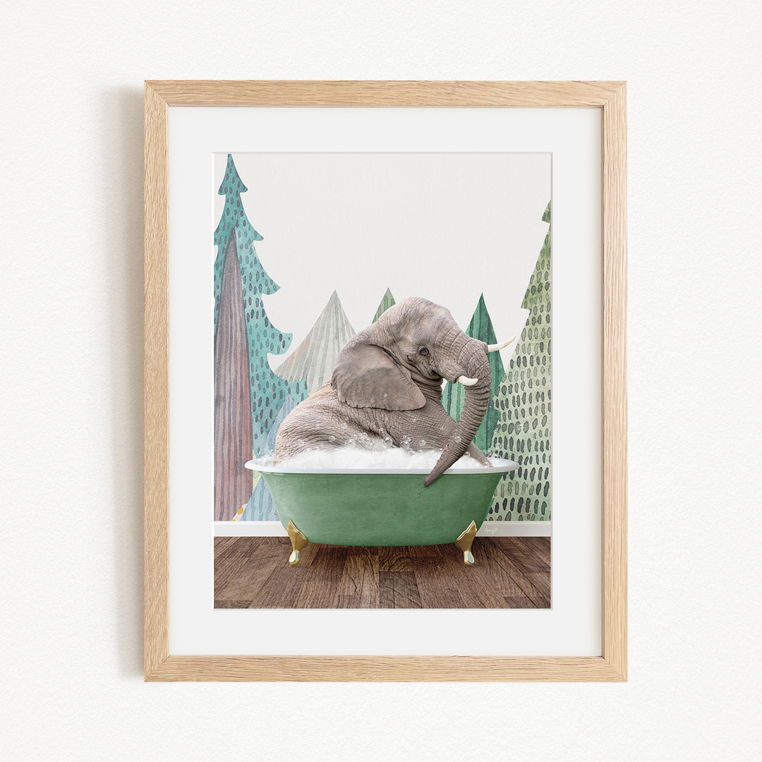 A gray elephant is sitting in a green bathtub, surrounded by a forest-like background with trees and a snowy landscape.