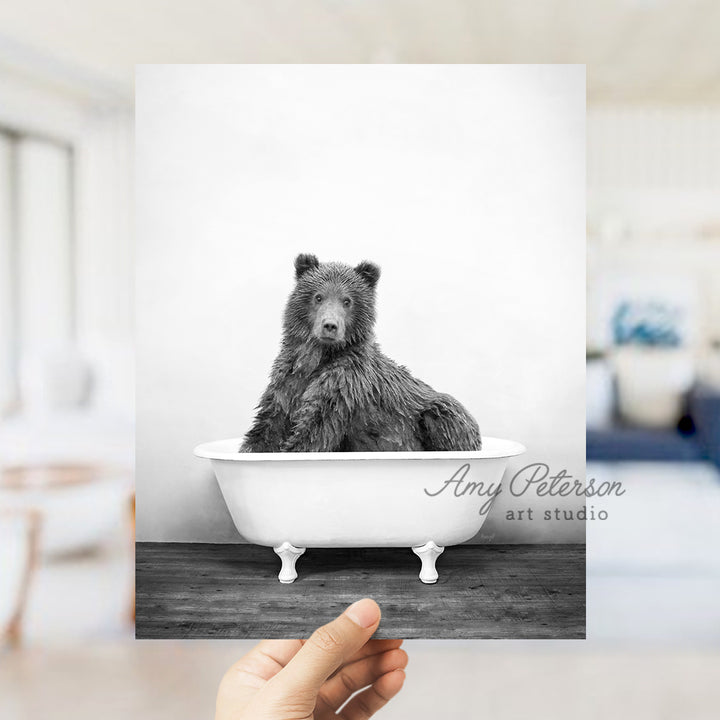 a black and white photo of a bear in a bathtub