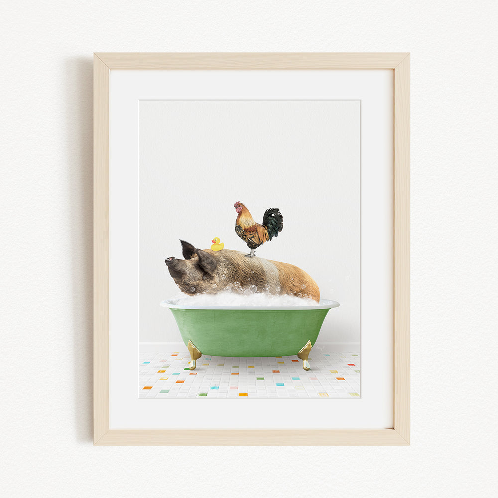 A framed image depicting a pig sitting in a green bathtub, with a rooster perched on its back and a yellow duck sitting on its belly.