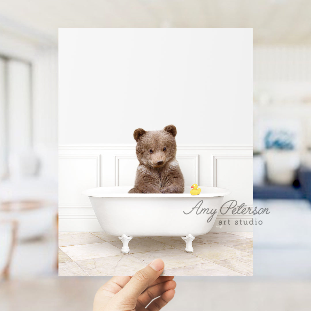 a person holding up a card with a picture of a bear in a bathtub