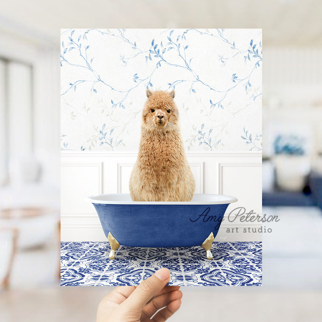 a hand holding a card with a picture of a llama in a bathtub