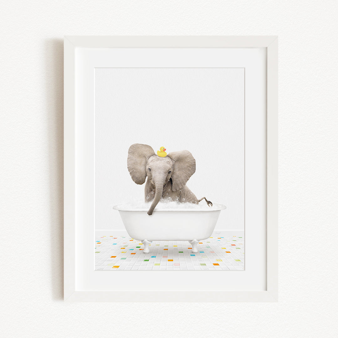 A baby elephant sitting in a white bathtub, with a yellow rubber duck floating on its head.