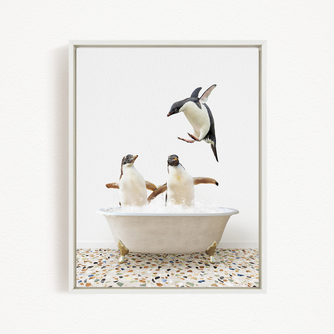 A framed image depicting three penguins in a bathtub, with one penguin flying above the tub.