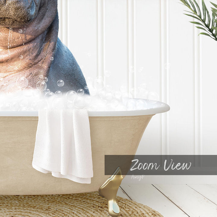 A bathtub filled with bubbles, with a towel hanging on the side and a plant in the background.