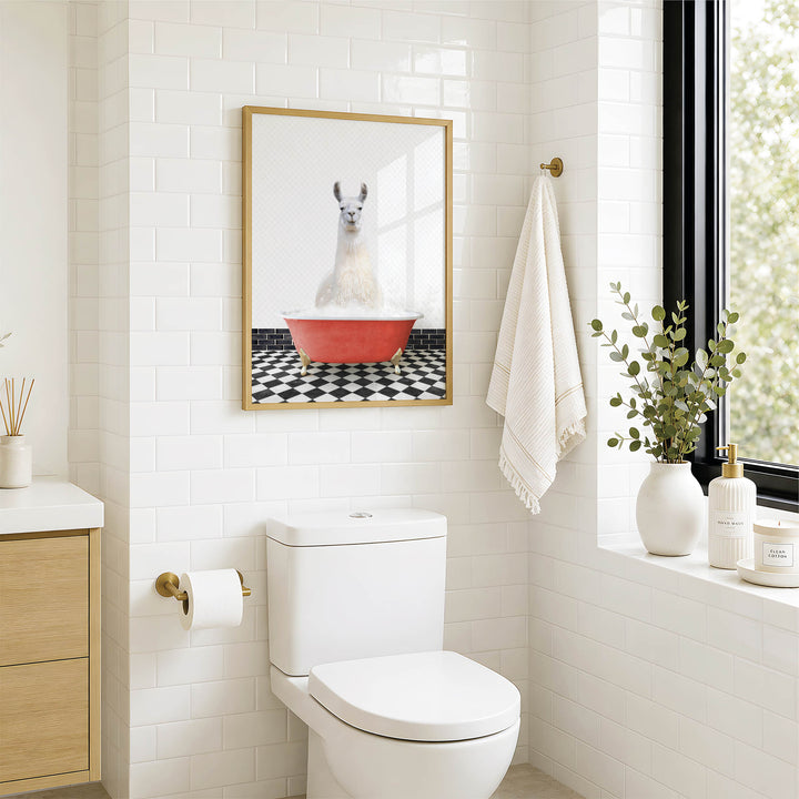 A bathroom with a white toilet, a framed picture of a llama in a red bathtub, and a window with greenery on the sill.