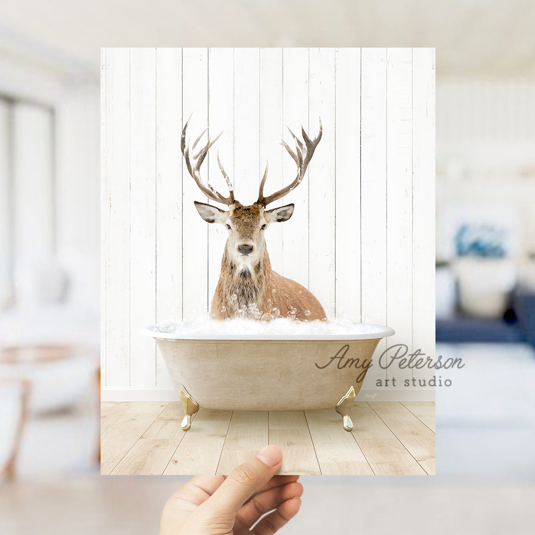 a hand holding a photo of a deer in a bathtub