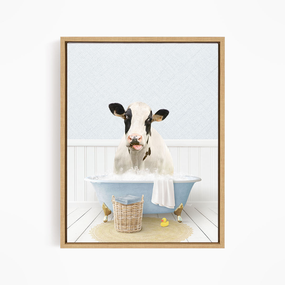 A black and white cow is sitting in a blue bathtub filled with water, surrounded by rubber ducks.