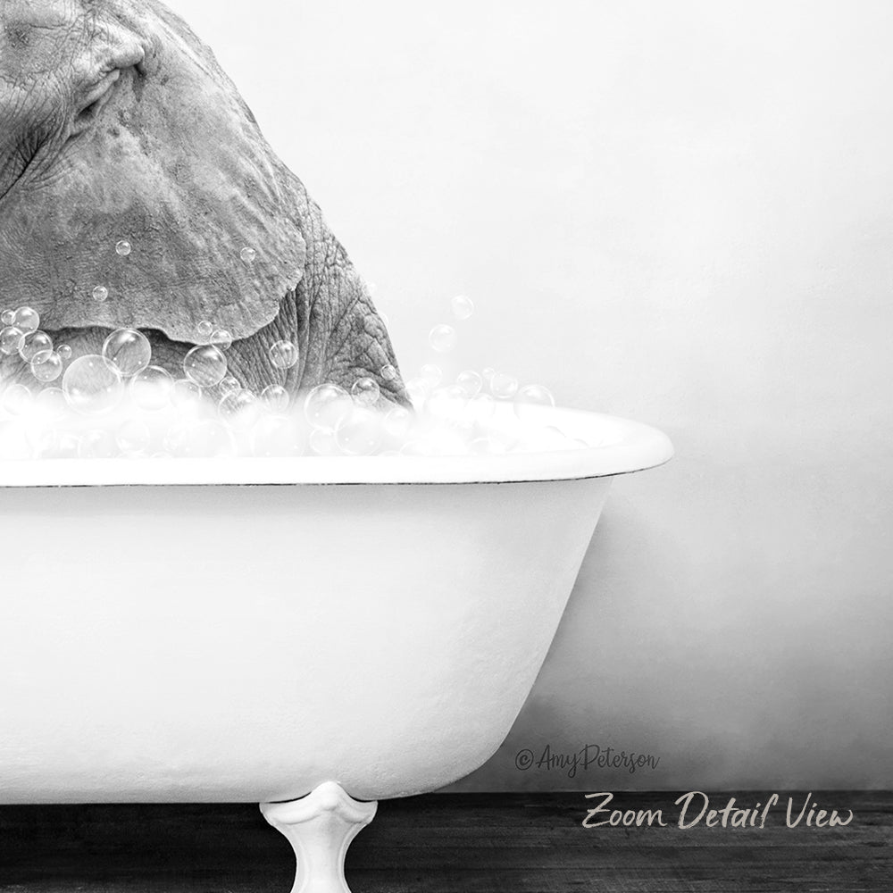A large elephant is taking a bath in a white bathtub filled with bubbles, creating a whimsical and playful scene.