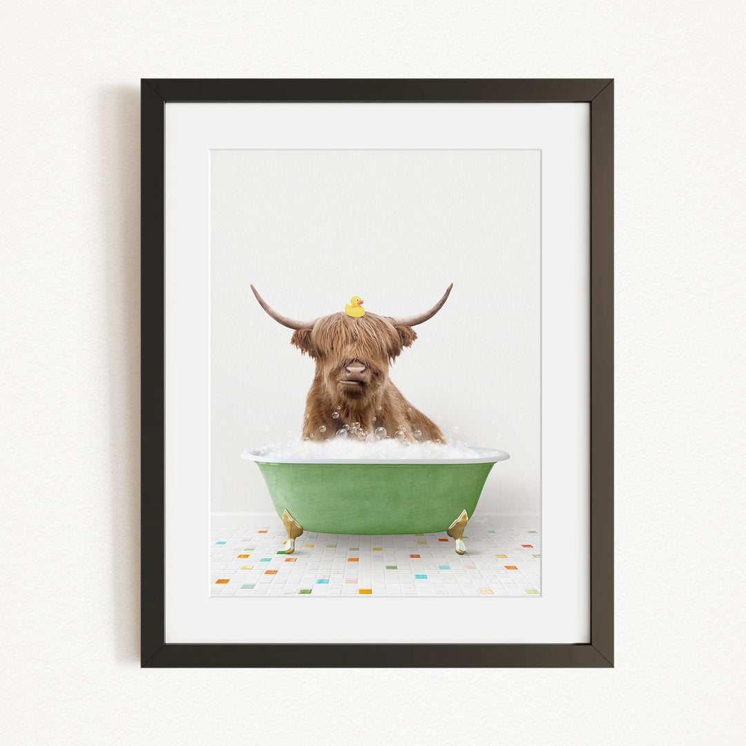 A brown cow with long horns is sitting in a green bathtub filled with bubbles, with a yellow rubber duck perched on its head.