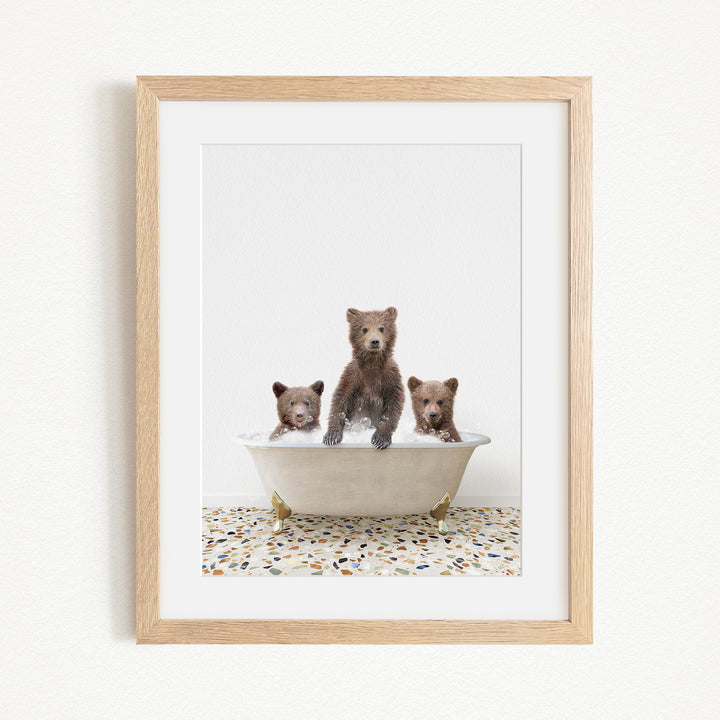 A framed image of three bears sitting in a bathtub, with one bear sitting in the center and the other two bears sitting on either side.