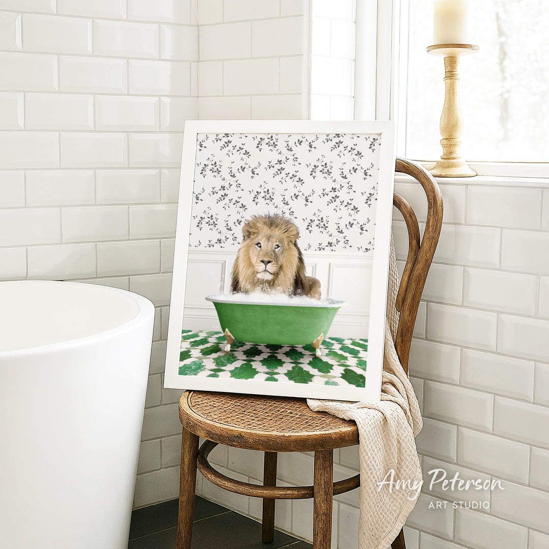 A framed image of a lion sitting in a green bathtub, surrounded by a patterned design, is displayed on a wooden chair in a bathroom setting.