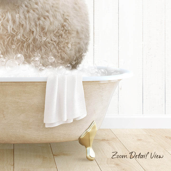 A fluffy white dog is sitting in a bathtub filled with bubbles, with a towel and gold bathtub leg visible.