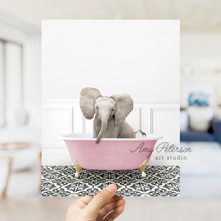 a hand holding a card with an elephant in a bathtub