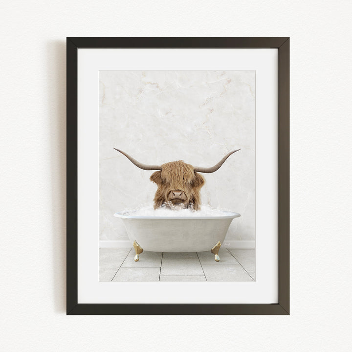 A framed image depicting a horned animal, likely a yak or a similar animal, sitting in a white bathtub filled with water.
