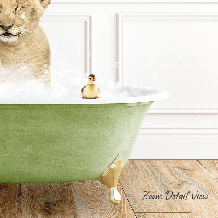 A lion cub is standing in a green bathtub filled with bubbles, while a small yellow duck sits on the edge of the tub.
